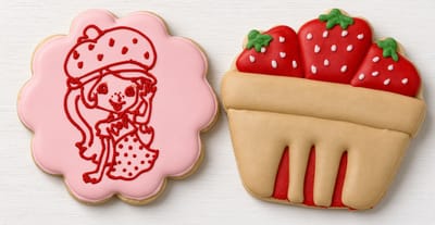 Strawberry Shortcake character plaque beside a berry basket cookie — custom decorated cookies by Dreams of Buttercream