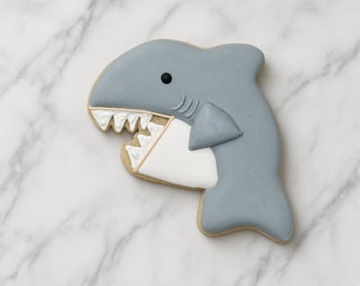 Grey shark cookie with piped teeth for an under-the-sea party — custom decorated cookies by Dreams of Buttercream
